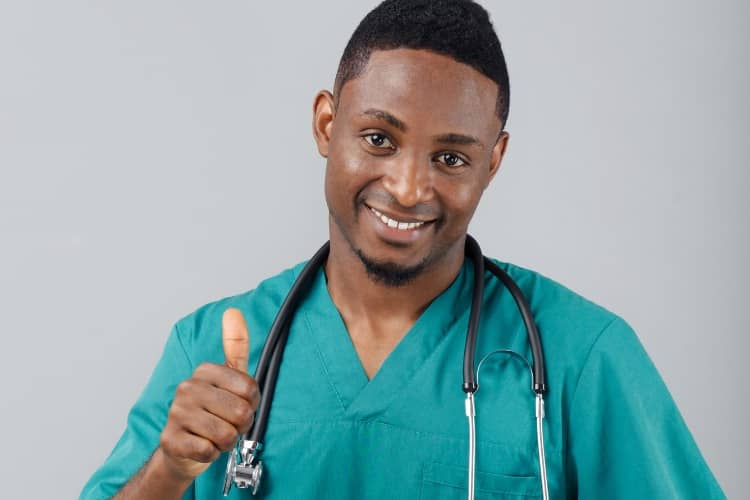 A male nurse gives a thumbsup