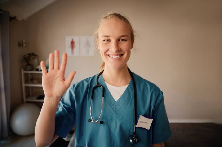 A nurse waves her hand